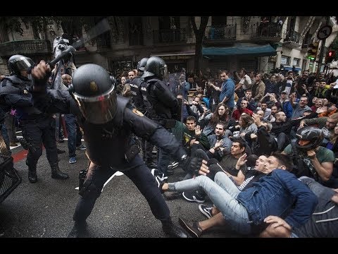 a policeman hitting demonstrators